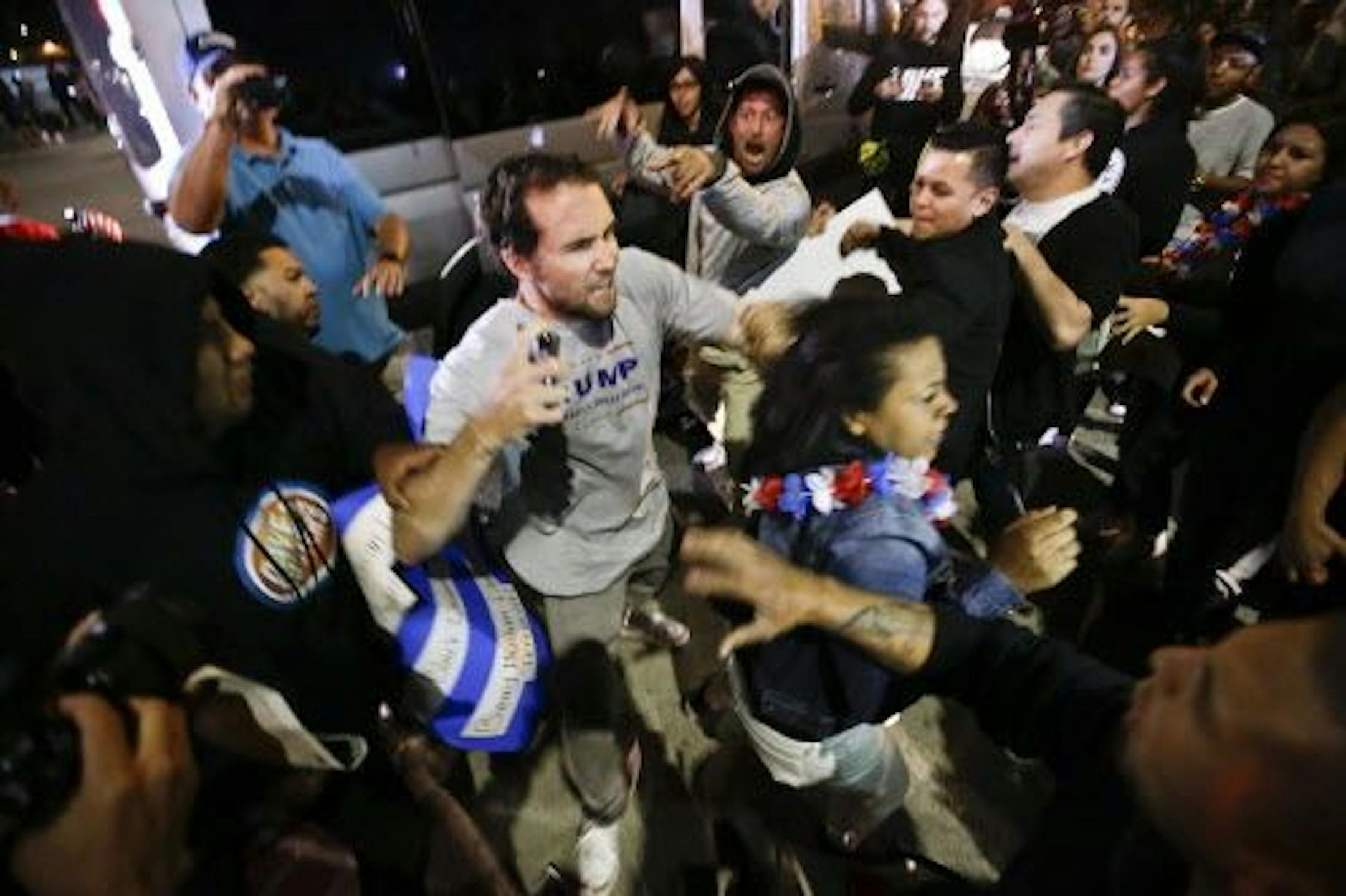 A Trump supporter clashes with protesters outside a rally for Republican presidential candidate Donald Trump, Thursday, April 28, 2016 in Costa Mesa, Calif.