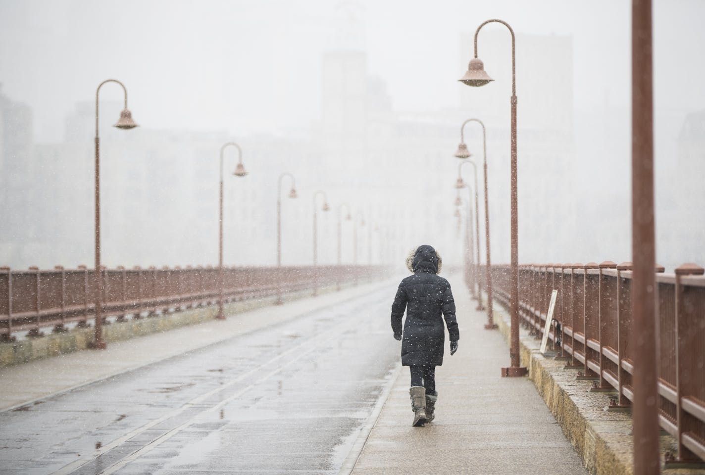 Carol Minger went for a walk to see the snow on the Stone Arch Bridge on October 27, 2017, in Minneapolis, Minn. "I love snow!" said Minger as she braved the chilly winds. ] RENEE JONES SCHNEIDER &#xef; renee.jones@startribune.com