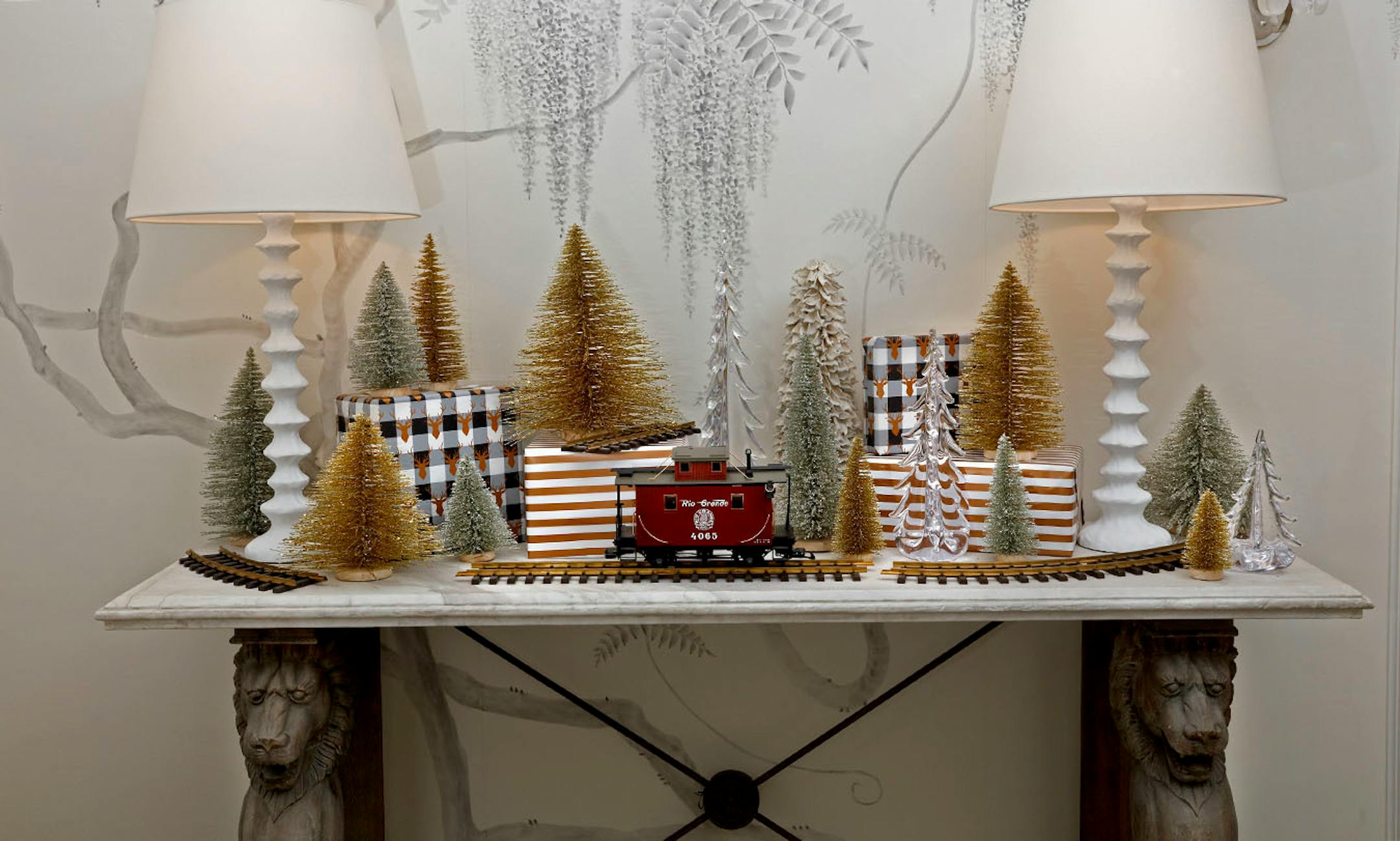 Silver and Gold: "Tinsel tree" scape for a foyer or console table. Choose objects with common elements such as the tree-shape and sparkly texture. For interest mix in trees of glass or dried leaves. Place the tallest and largest trees in the center and build from there.To create a variety of heights and dimension, place some trees on top of boxes wrapped in simple-patterned paper repeating the colors in the tree display. Blend in a few pieces from another collection, such as an antique red caboo
