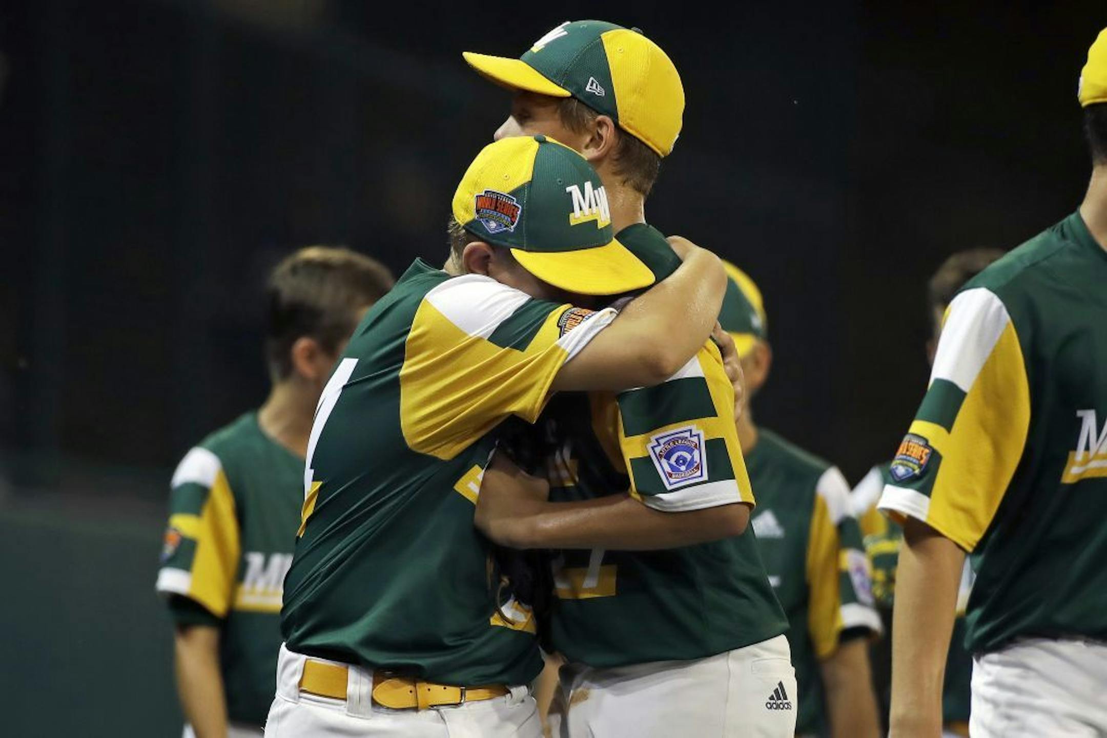 The Coon Rapids, Minnesota's Cameron Sakry, left, and Brett Buettner hug after losing 10-0 to River Ridge, Louisiana in an elimination baseball game at the Little League World Series tournament in South Williamsport, Pa., Monday, Aug. 19, 2019.