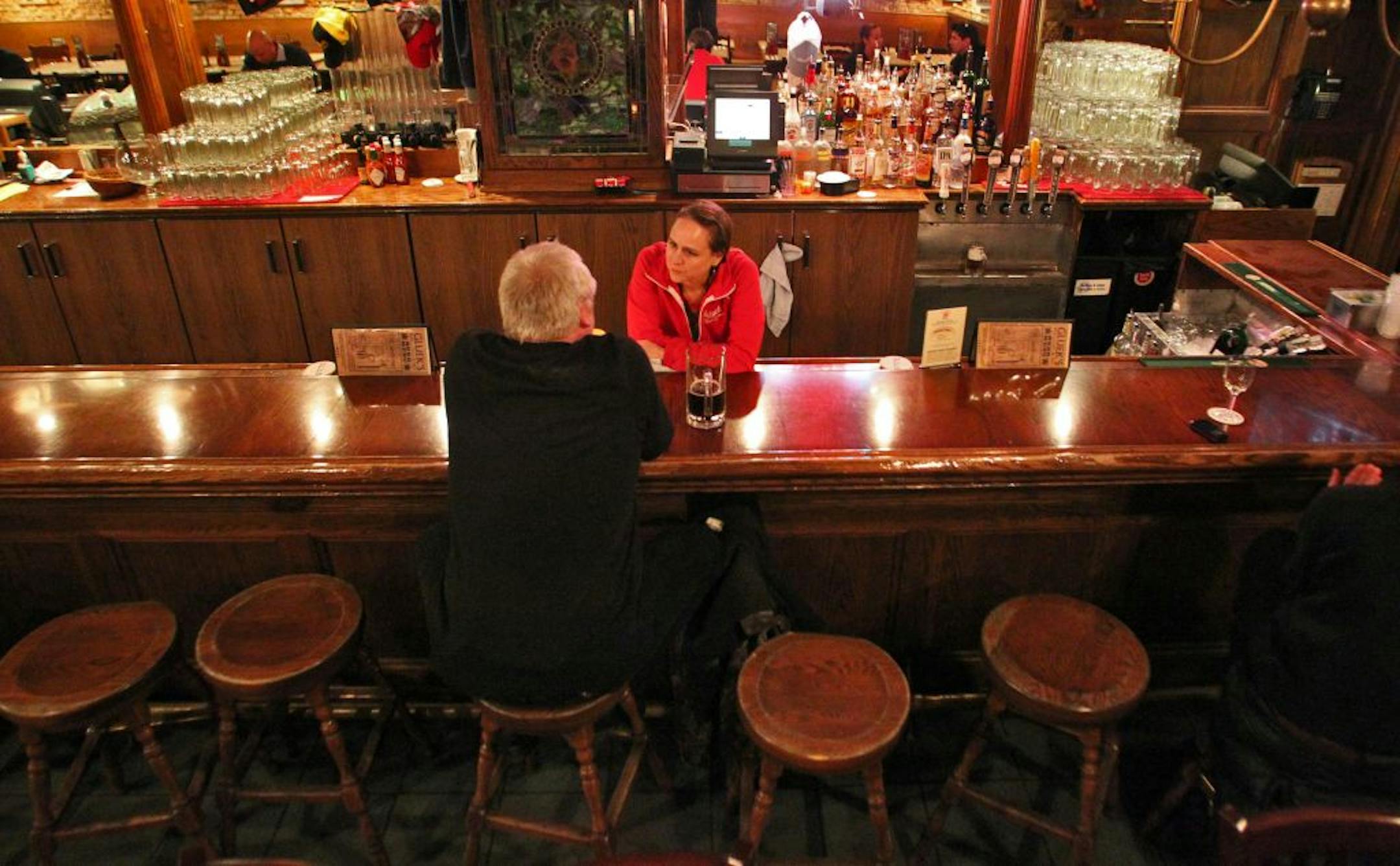 Gluek's General Manager Donna Fyten chatted with a customer on a quiet night when the Timberwolves should have been playing at nearby Target Center.
