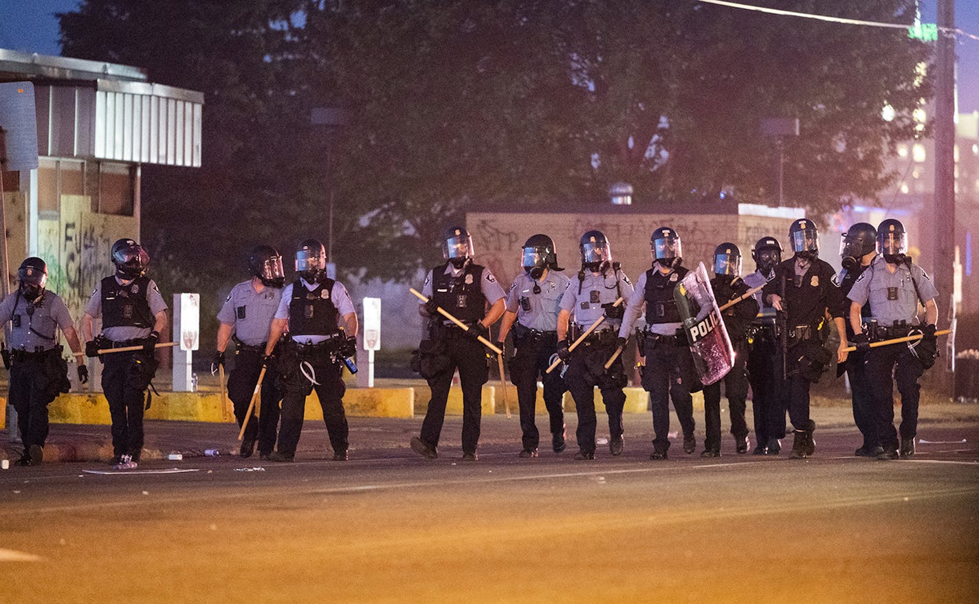 Minneapolis police have a huge presence outside the Minneapolis Police 5th Precinct after 9 p.m., keeping protesters away from the area with a show of force and chemical deterrents, on Saturday, May 30, 2020 in Minneapolis, Minn. (Leila Navidi/Minneapolis Star Tribune/TNS) ORG XMIT: 1676159