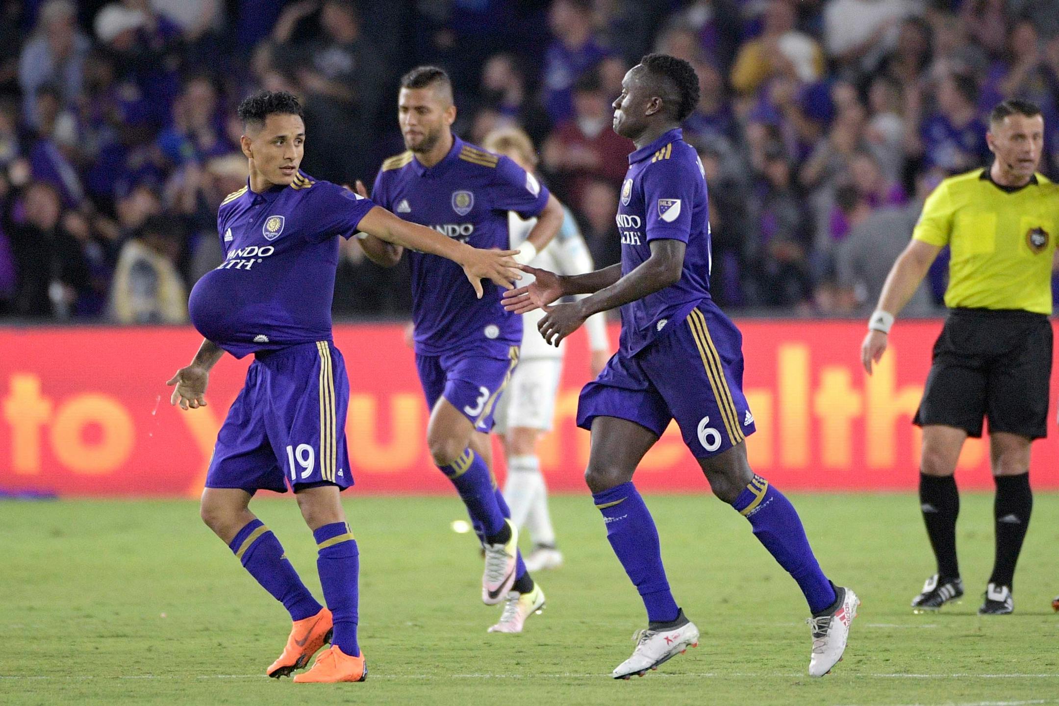 Orlando City defender Yoshimar Yotun (19) is congratulated by midfielder Richie Laryea (6) after scoring a goal during the first half of an MLS soccer match against Minnesota United Saturday, March 10, 2018, in Orlando, Fla. Minnesota won 2-1. (Phelan M. Ebenhack for the Star-Tribune) ORG XMIT: OTKMINN124