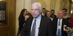 Sen. John McCain, R-Az., is pursued by reporters after casting a 'no' vote on a a measure to repeal parts of former President Barack Obama's health ca