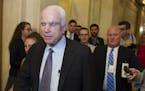 Sen. John McCain, R-Az., is pursued by reporters after casting a 'no' vote on a a measure to repeal parts of former President Barack Obama's health ca