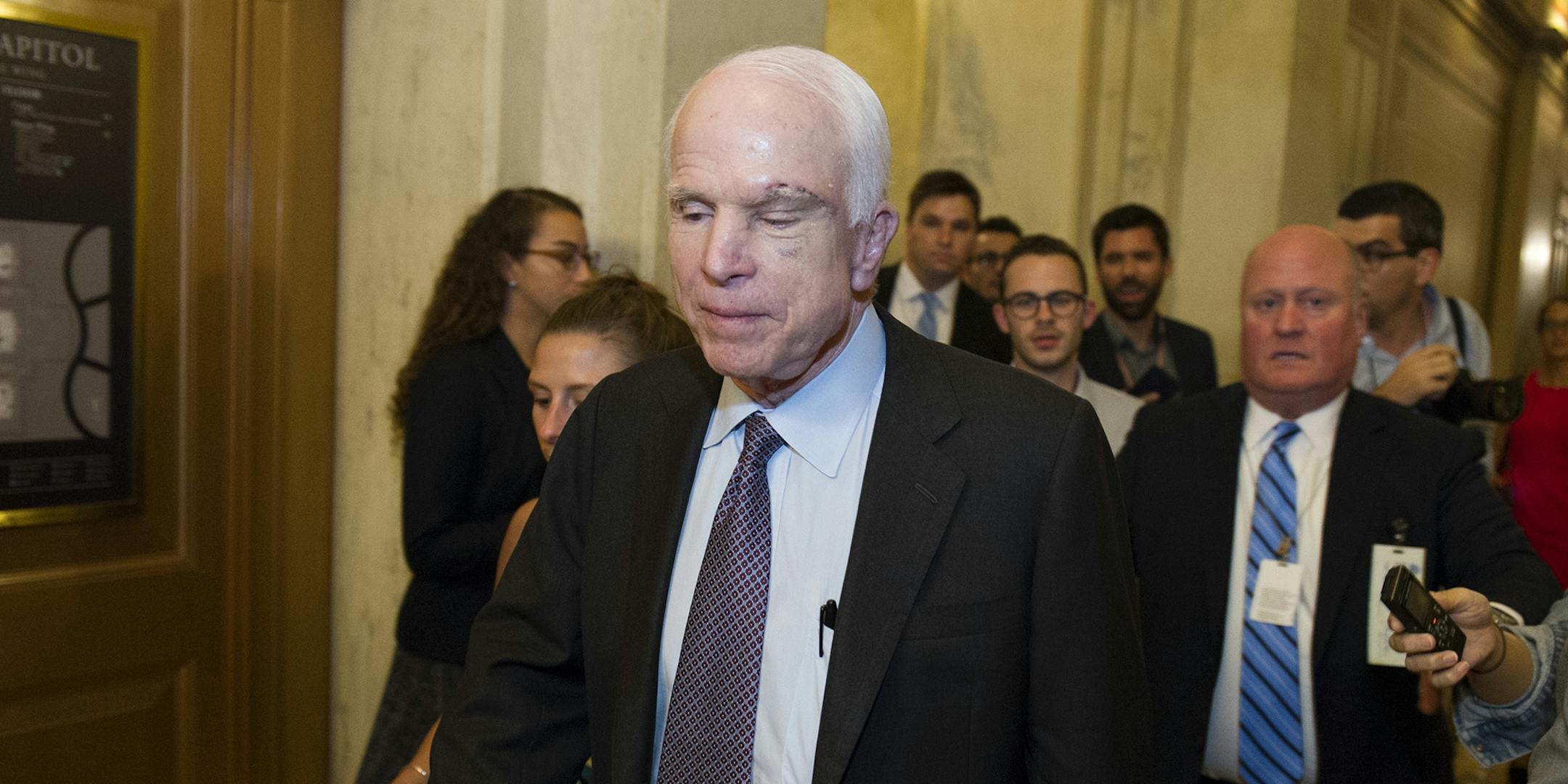 Sen. John McCain, R-Az., is pursued by reporters after casting a 'no' vote on a a measure to repeal parts of former President Barack Obama's health care law, on Capitol Hill in Washington, Friday, July 28, 2017. (AP Photo/Cliff Owen) ORG XMIT: DCCO133