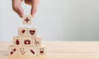 iStock
Hand arranging wood block stacking with icon healthcare medical, Insurance for your health concept