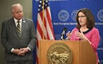 Minnesota Education Commissioner Mary Cathryn Ricker speaks, as Gov. Tim Walz listens during a news conference concerning the state's efforts against 