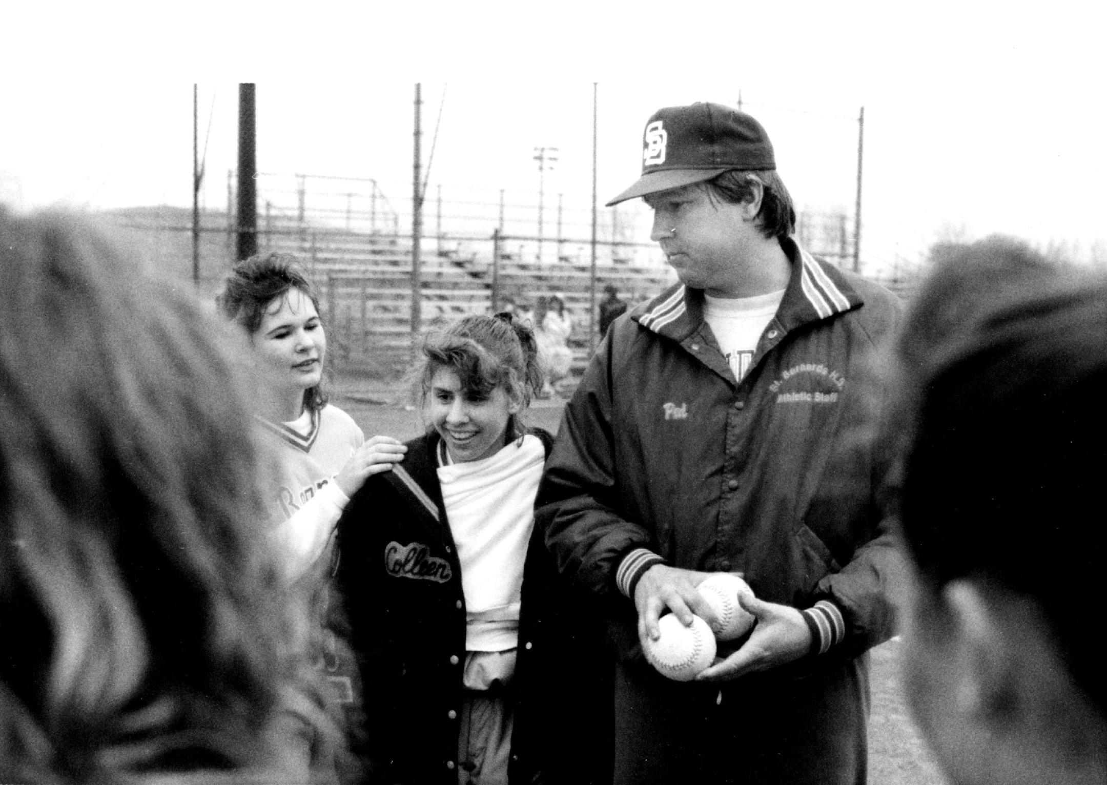 April 8, 1991 Coach Pat Bowlin talks to his team after winning again Mahtomedi. To the left of Bowlin is (r. to l.) Rachelle Mondry (#7) and Erin Williams #16). St. Bernard's coach Pat Bowlin talked to his team after it beat Mahtomedi 19-2 Monday for its state-record 50th straight victory. April 11, 1991 David Brewster, Minneapolis Star Tribune