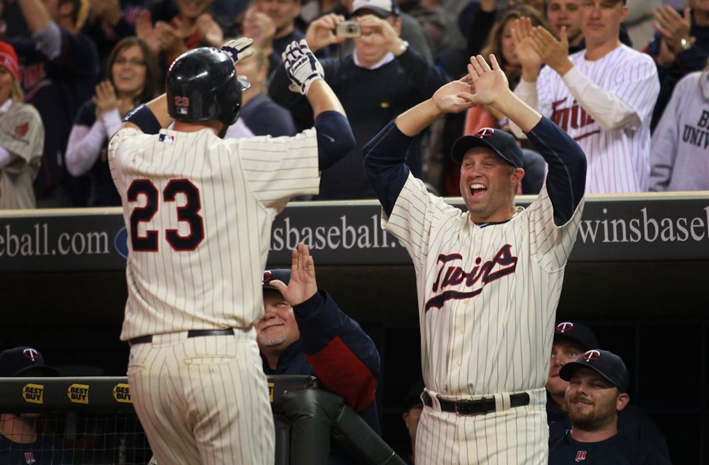 Minnesota Twins' Michael Cuddyer, right, celebrates with Rene Tosoni (23), who was atken in the 38th round of the 2005 dradft. Tosoni played for the Twins in 2011 and now plays for an independent league team in South Dakota.