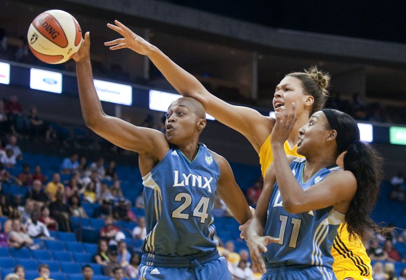 Minnesota Lynx's Charde Houston (24) is fouled on a reach by Tulsa Shock's Liz Cambage during the second quarter of a WNBA basketball game Thursday, June 30, 2011, in Tulsa, Okla.