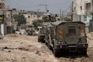 Israeli military vehicles are seen during a raid in the West Bank Jenin refugee camp, Tuesday, May 21, 2024. Israeli forces raided a militant strongho