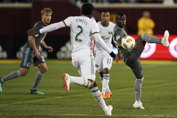Minnesota United forward Carlos Darwin Quintero (25) tried to get a piece of the ball of a high pass in the first half while being guarded by Portland