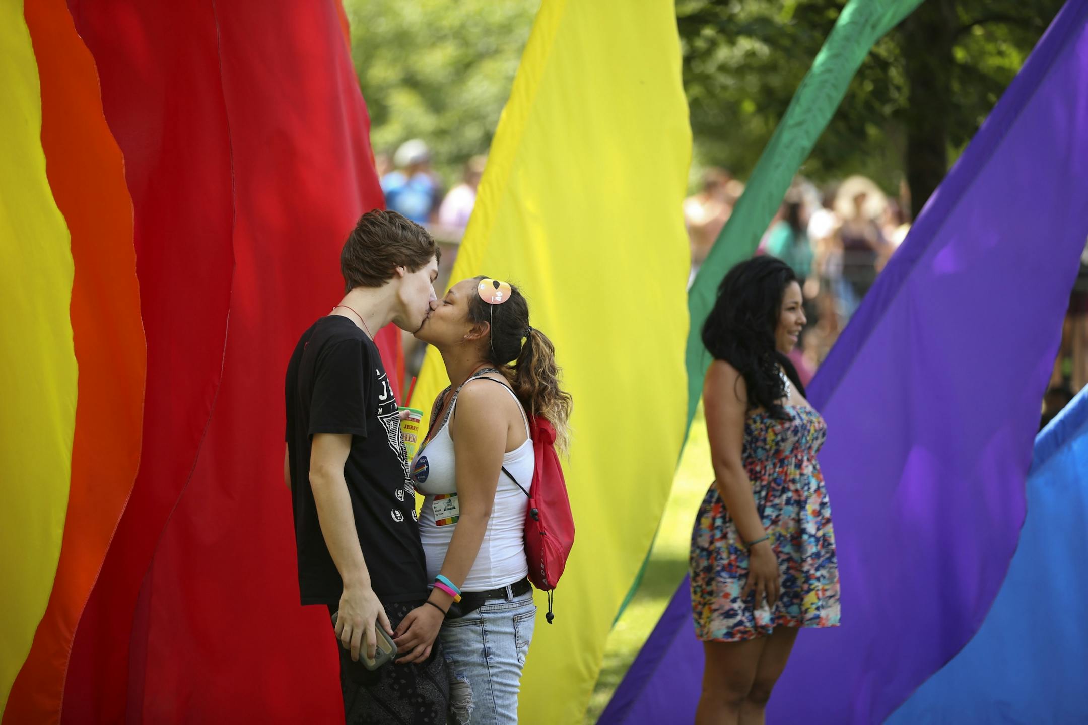 E.J. Johnson and Aiyana Buck kissed near an array of flags in Loring Park Sunday afternoon.