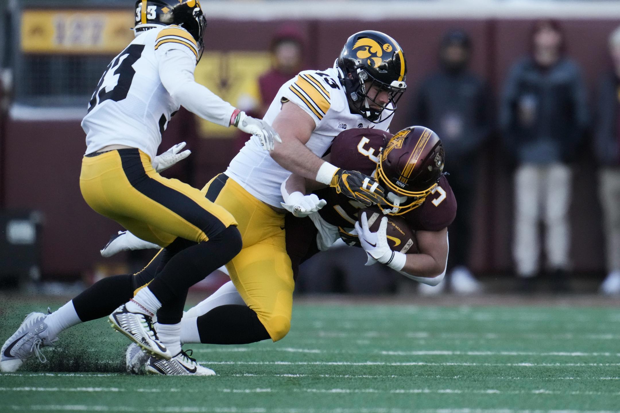 Iowa Hawkeyes defensive end Joe Evans (13) tackled Minnesota Gophers running back Trey Potts (3) in the first quarter.