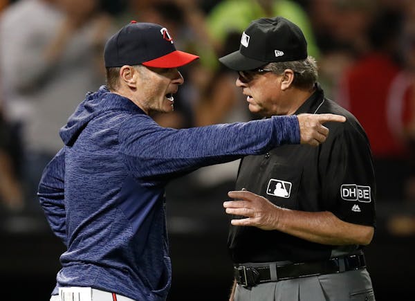 Minnesota Twins' manager Paul Molitor, left, argues with third base umpire Gerry Davis during the sixth inning