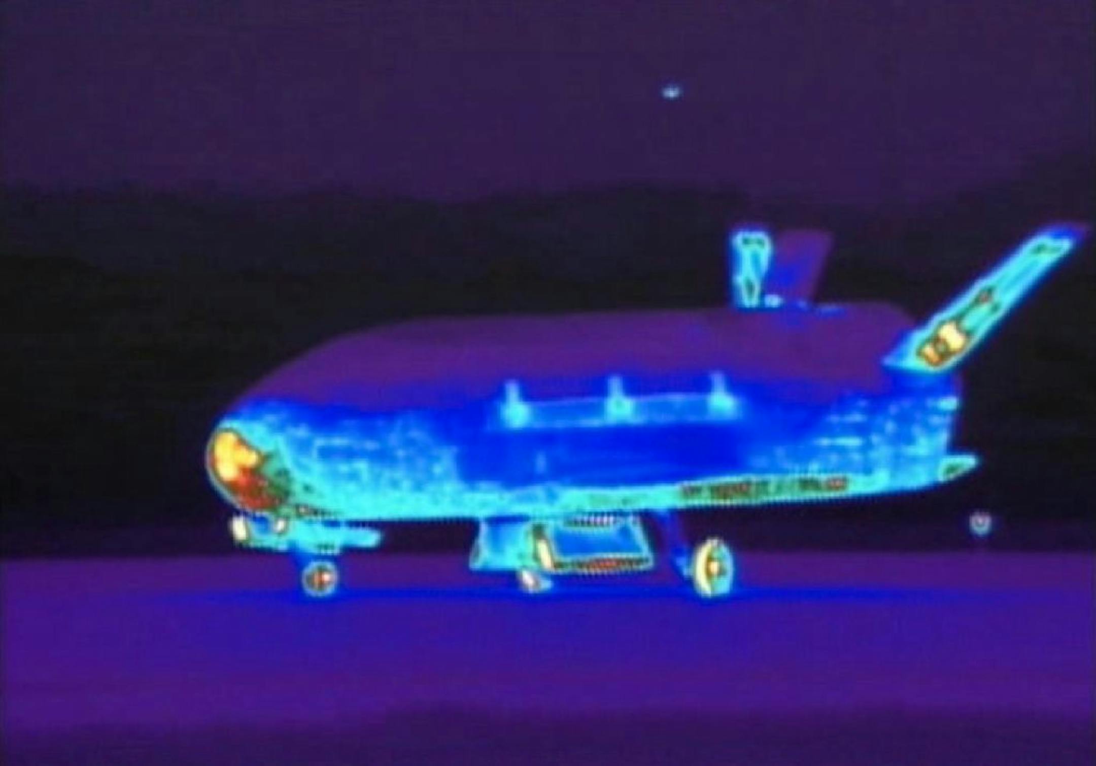 This June 16, 2012 file image from video made available by the Vandenberg Air Force Base shows an infrared view of the X-37B unmanned spacecraft landing at Vandenberg Air Force Base. The purpose of the U.S. military's space plane is classified, only fueling speculation about why it has been orbiting Earth for nearly two years on this, its third mission. The plane is expected to land this week at a Southern California Air Force base.