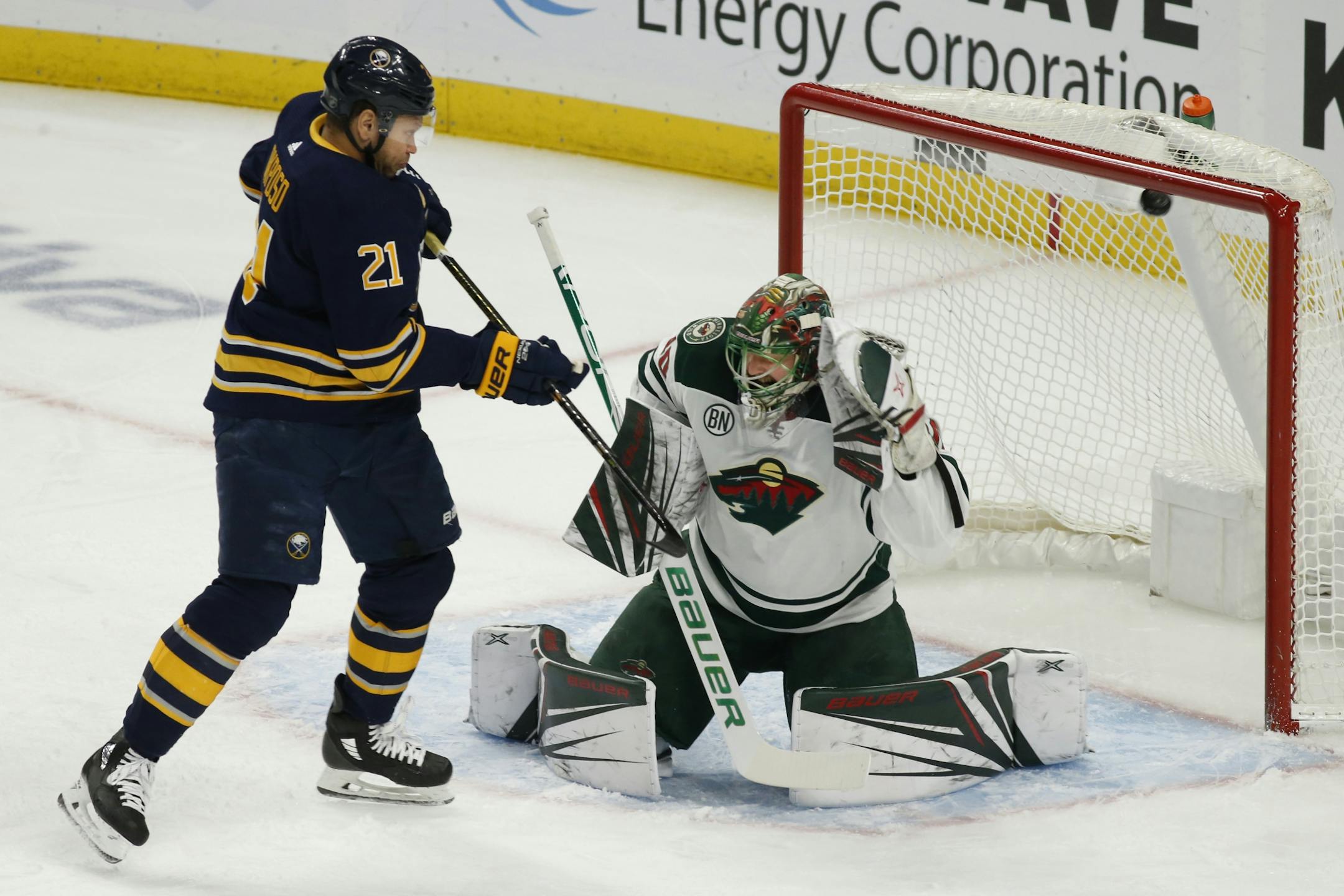 Buffalo Sabres forward Kyle Okposo (21) watches the puck go past Minnesota Wild goalie Devan Dubnyk (40) during the first period of an NHL hockey game, Tuesday, Feb. 5, 2019, in Buffalo N.Y.