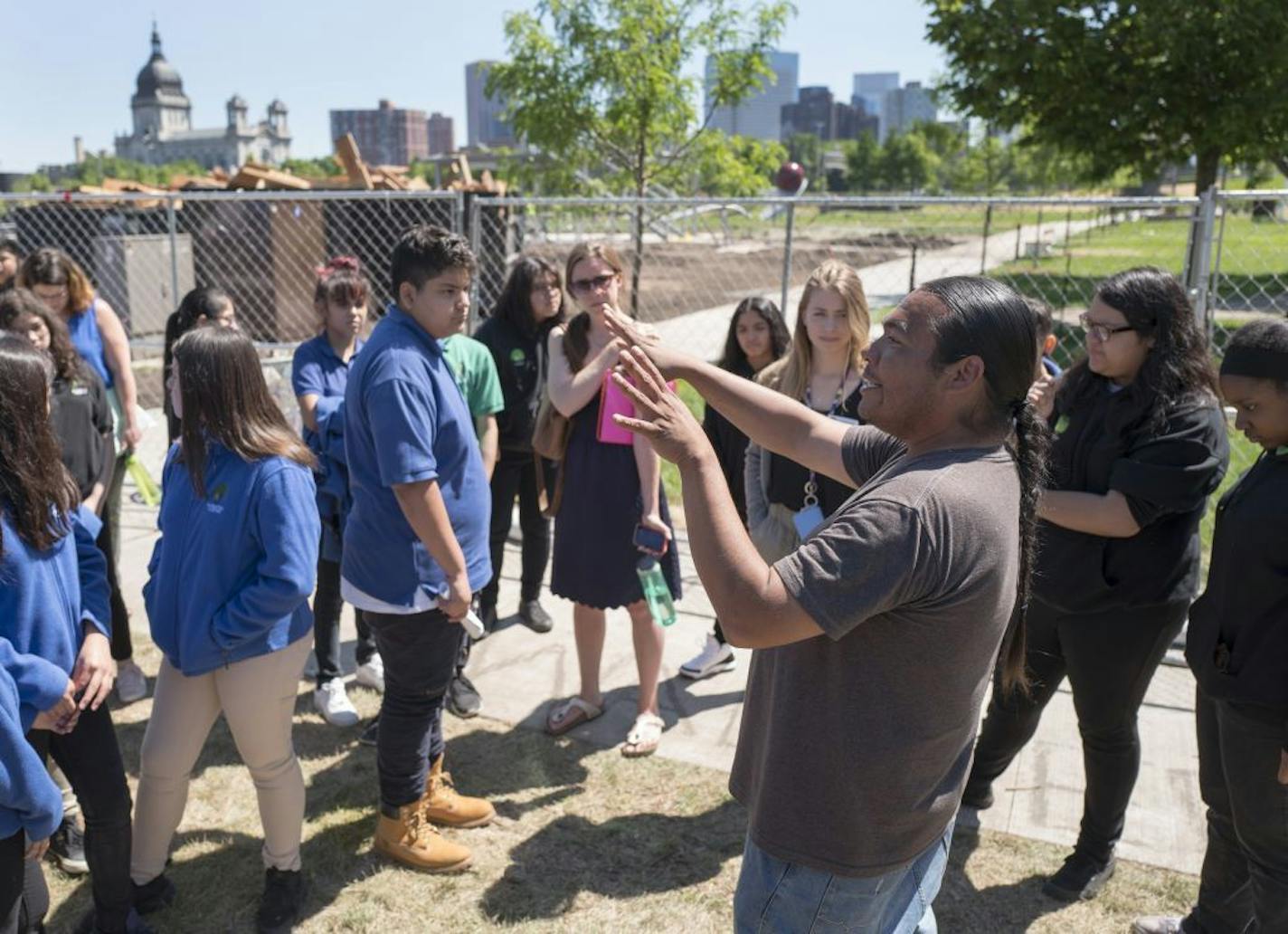 Sam Wounded Knee talked to students from Hiawatha College Prep school about why the "Scaffold" sculpture had to come down at the Walker Sculpture garden. Piles of cedar wood from the "Scaffold" sculpture after it was dismantled were placed in a dumpster at the Walker Sculpture Garden Monday June 5, 2017 in Minneapolis, MN.