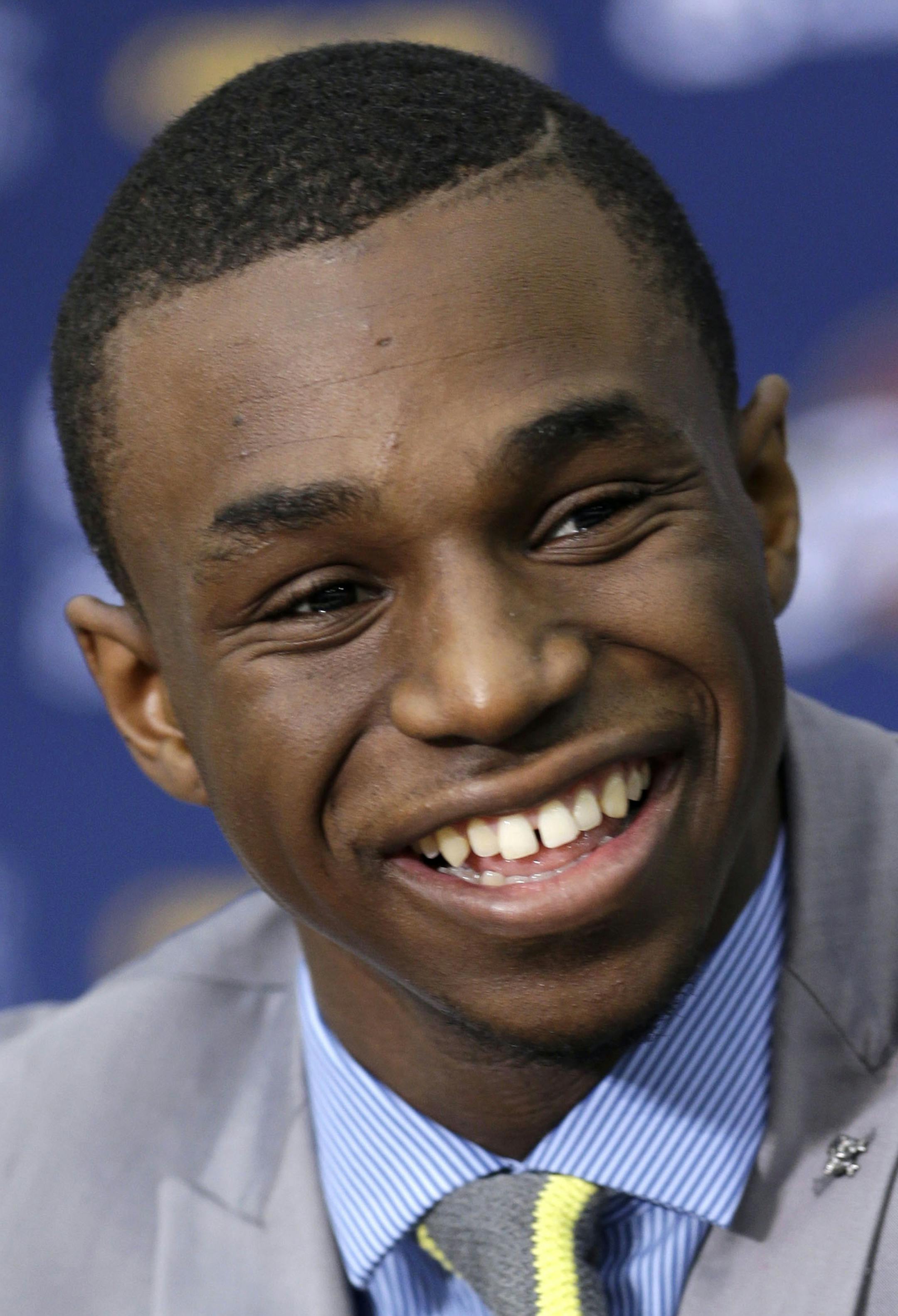 FILE - In this June 27, 2014, file photo, Cleveland Cavaliers draft pick Andrew Wiggins smiles during an NBA basketball conference in Independence, Ohio. Two people with knowledge of the deal tell The Associated Press that Minnesota and Cleveland have agreed to a trade that will send All-Star forward Kevin Love to the Cavaliers for Wiggins, Anthony Bennett and a future first-round draft pick. The two people spoke Thursday, Aug. 7, 2014, on condition of anonymity because no official agreement can