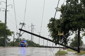 Garland police block traffic due to a downed power line, Tuesday, May 28, 2024, in Garland, Texas. Strong storms with damaging winds and hail pummeled