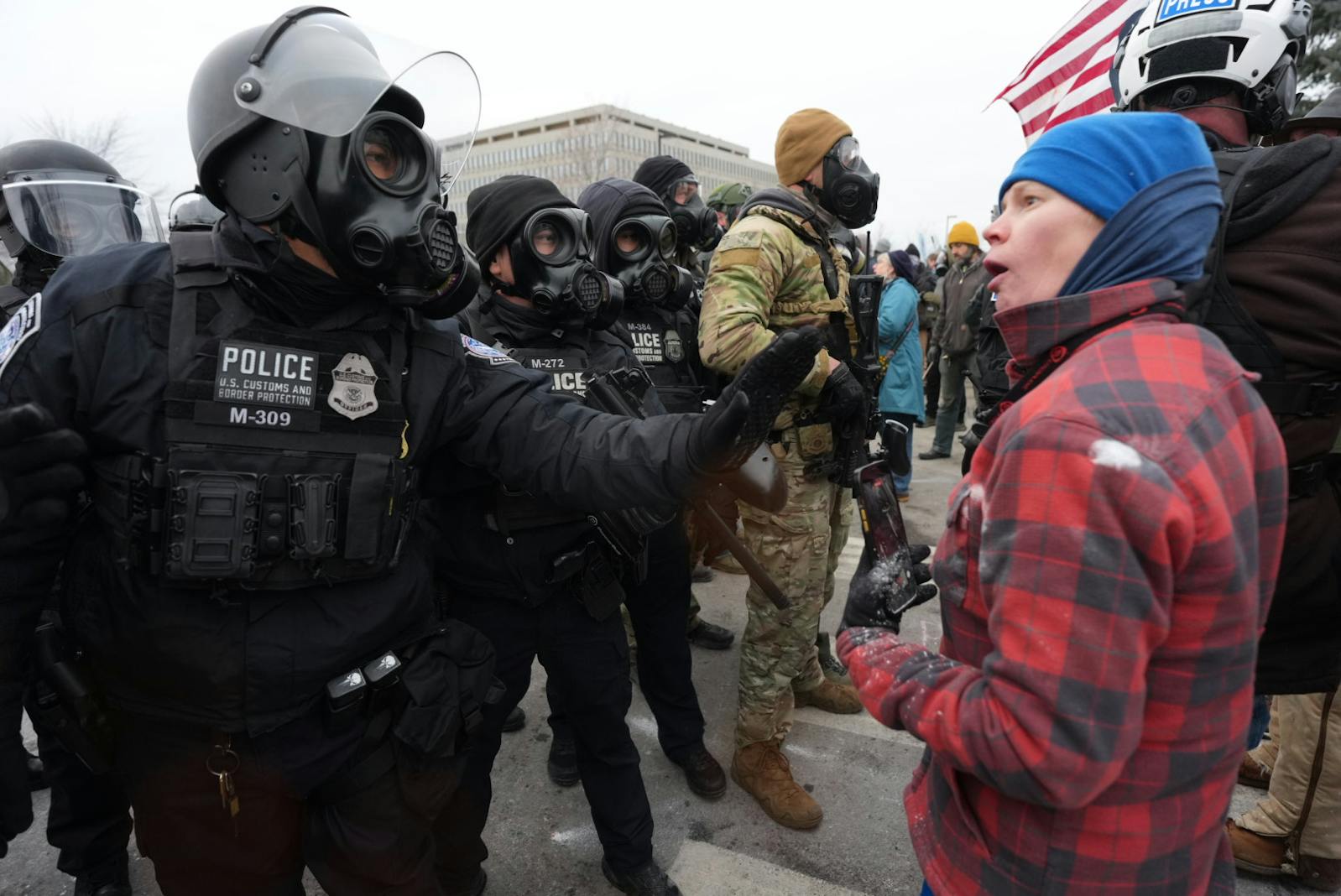 A federal agent and a protester face off outside near the Whipple Federal Building at Fort Snelling on Jan. 16. 