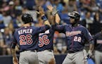 The Twins' Miguel Sano (22) celebrated with Max Kepler and Robbie Grossman (36) after hitting a three-run home run off Rays starter Matt Andriese duri