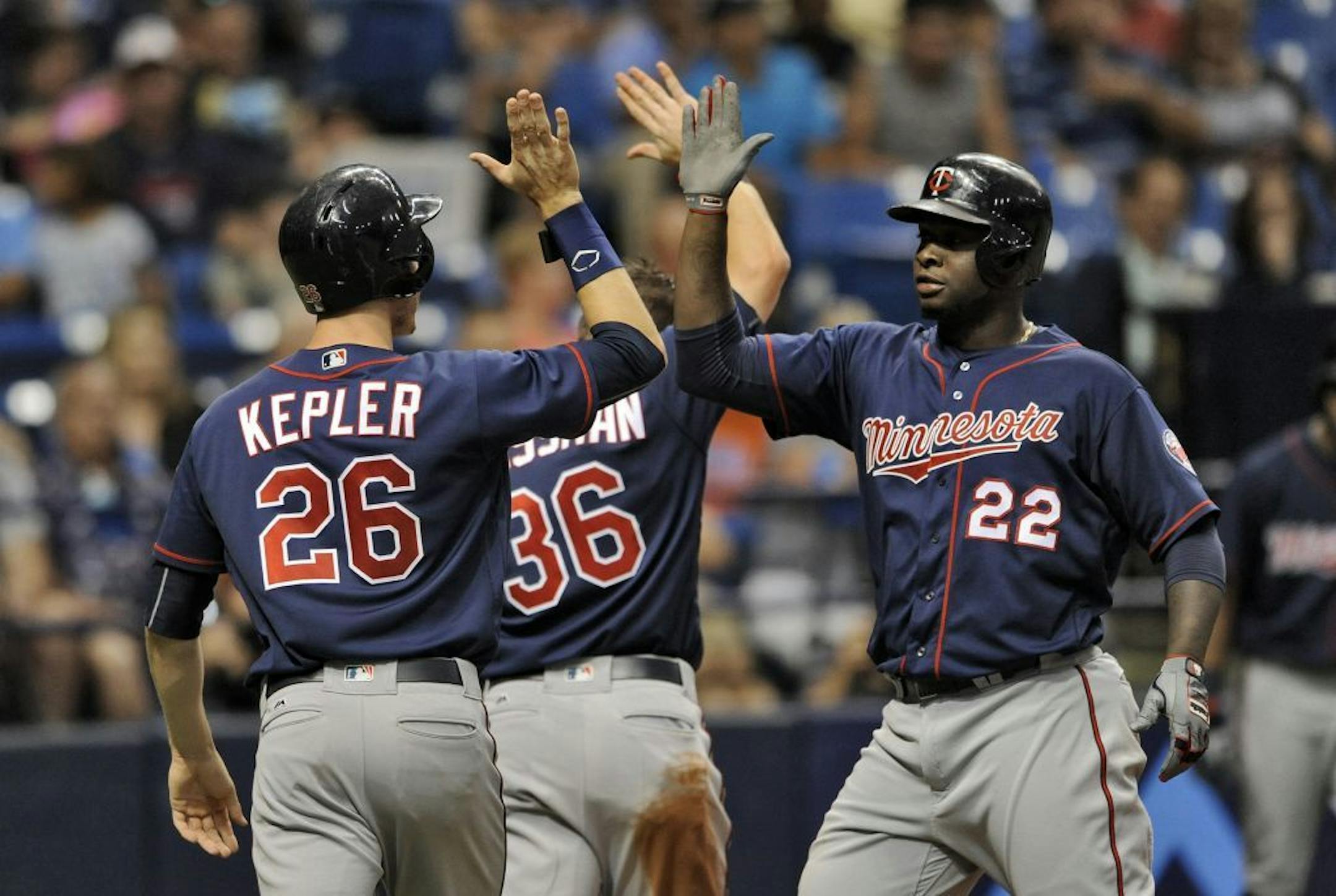 The Twins' Miguel Sano (22) celebrated with Max Kepler and Robbie Grossman (36) after hitting a three-run home run off Rays starter Matt Andriese during the third inning Sunday.