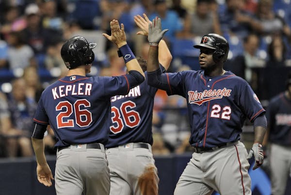 The Twins' Miguel Sano (22) celebrated with Max Kepler and Robbie Grossman (36) after hitting a three-run home run off Rays starter Matt Andriese duri