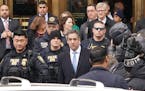 FILE -- Michael Cohen, President Donald Trump's former personal lawyer, walks out of his sentencing in New York, Dec. 12, 2018.