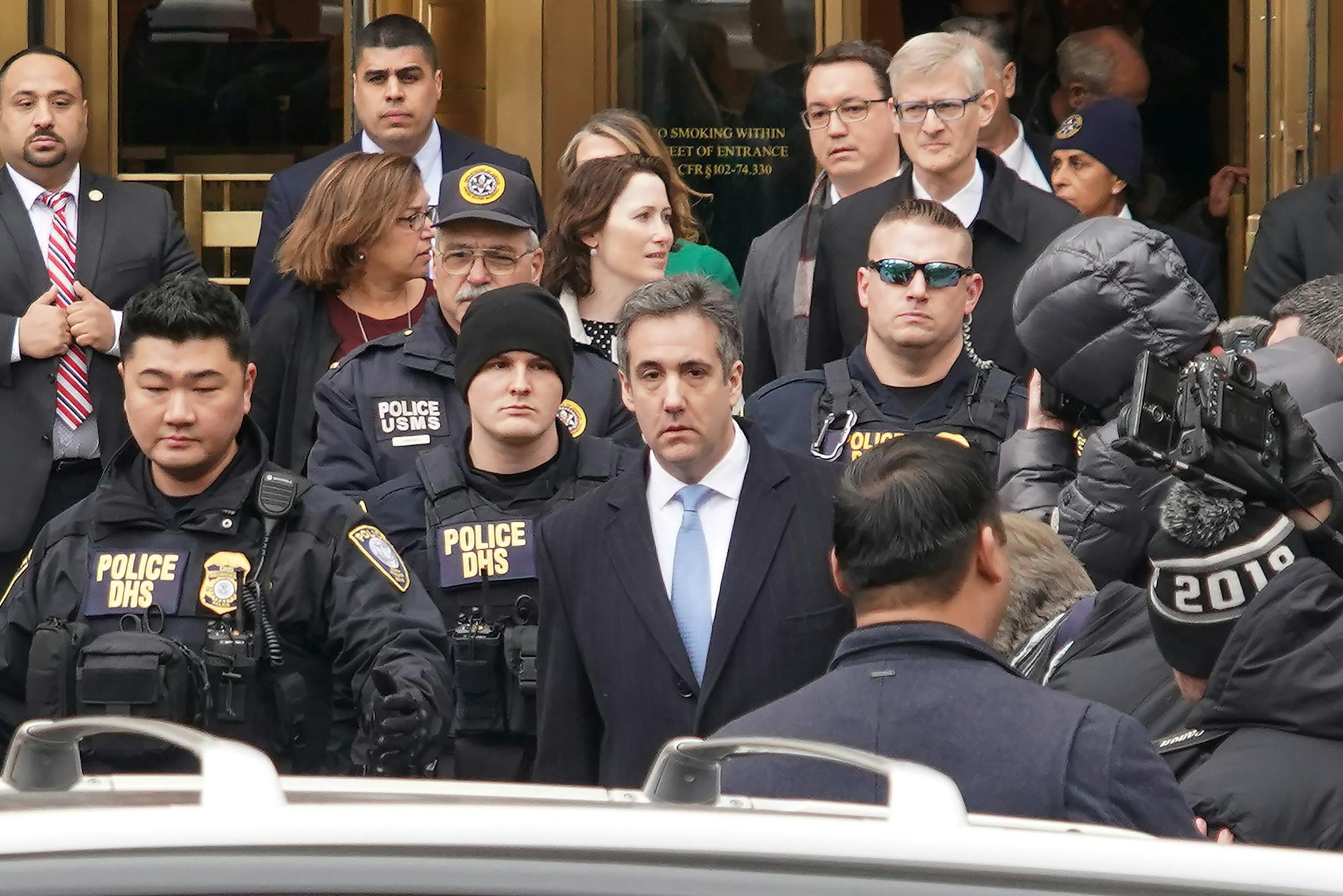 FILE -- Michael Cohen, President Donald Trump's former personal lawyer, walks out of his sentencing in New York, Dec. 12, 2018.