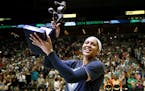 Maya Moore held up her WNBA MVP trophy to the Target Center crowd.