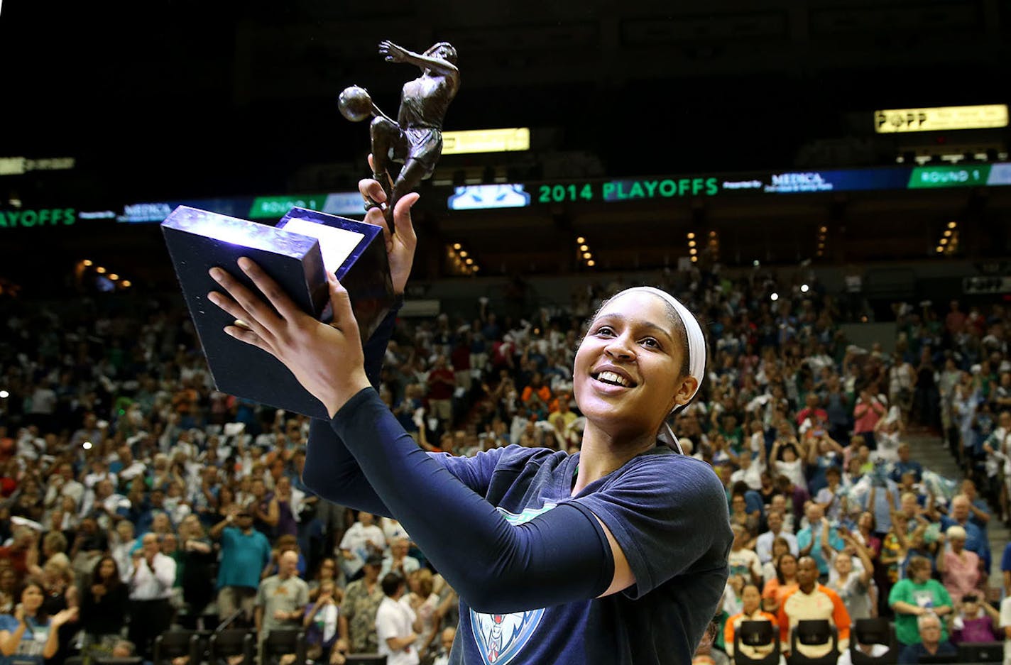 Maya Moore held up her WNBA MVP trophy to the Target Center crowd.