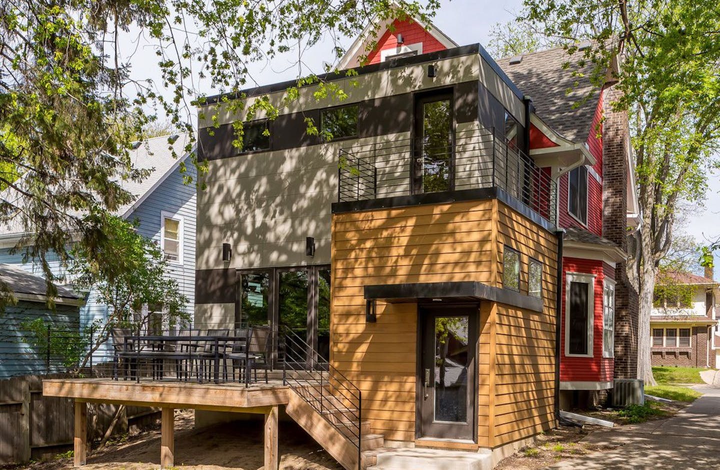 The modern-style rear addition offers a dramatic contrast to the home&#x2019;s traditional architecture in front. The rear of the home and kitchen before renovations.