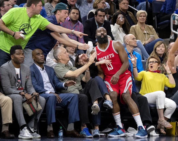 James Harden (13) fell into the first row in the fourth quarter of Saturday's game at Target Center and the scene went viral on social media.