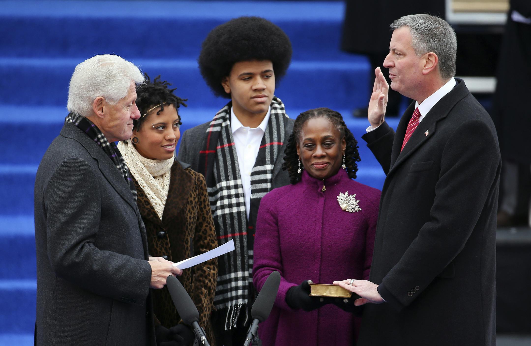 Mayor Bill de Blasio takes the oath of office on a Bible held by his wife, Chirlane McCray, at City Hall in New York, Jan. 1, 2014. Looking on are their children, Chiara and Dante, and former President Bill Clinton, who administered the oath and also delivered a strong endorsement of the de Blasio and his assertively liberal campaign. (Chang W. Lee/The New York Times)