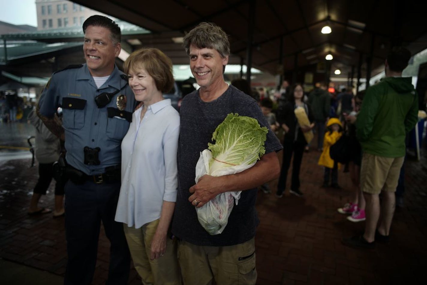 Senator Tina Smith met with constituents, including police officer Darin McDonald and Jim Golden of Golden's Deli at the St. Paul Farmers Market and discussed the Farm Bill.