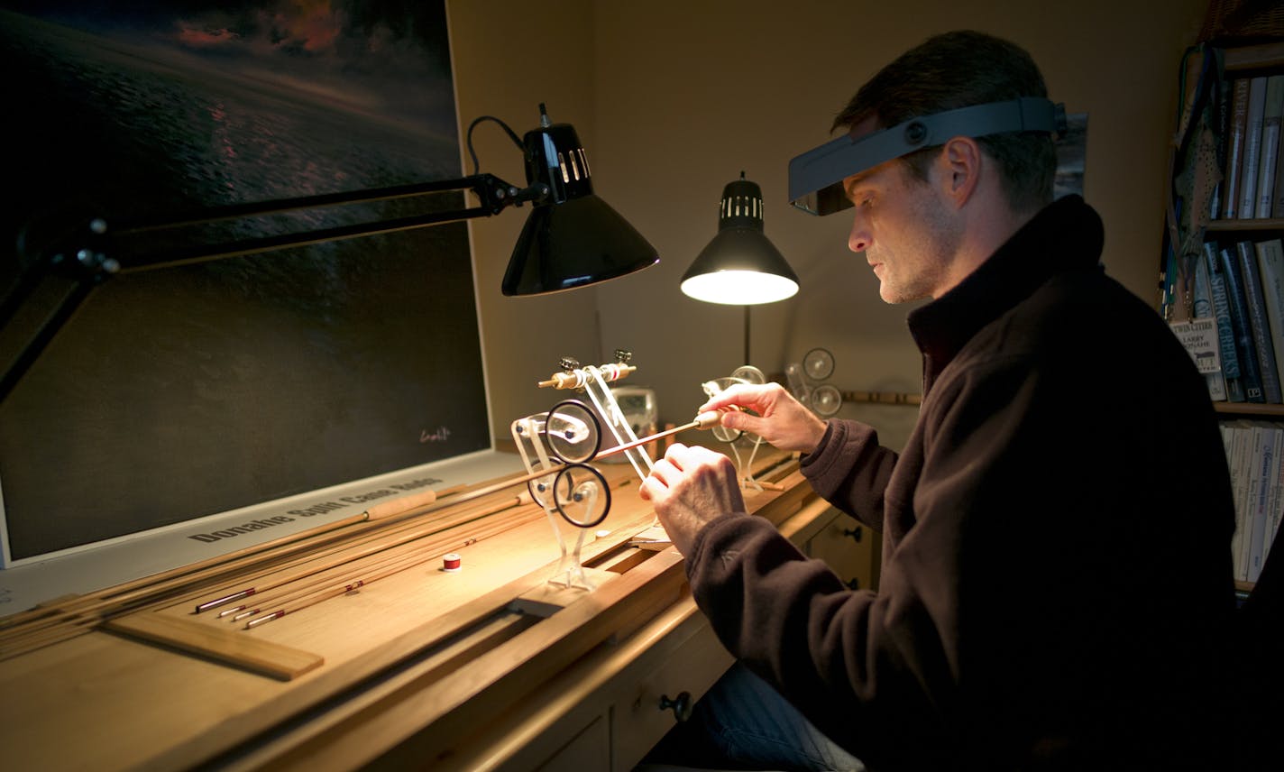 Larry P Donahe of Victoria who owns Split Cane Rods make high-end bamboo rods that are wrapped in silk thread. He is wrapping parts of the rod in silk thread. A rod can take 50 hours and cost upwards of $1800.]richard tsong-taatarii/rtsong-taataarii@startribune.com