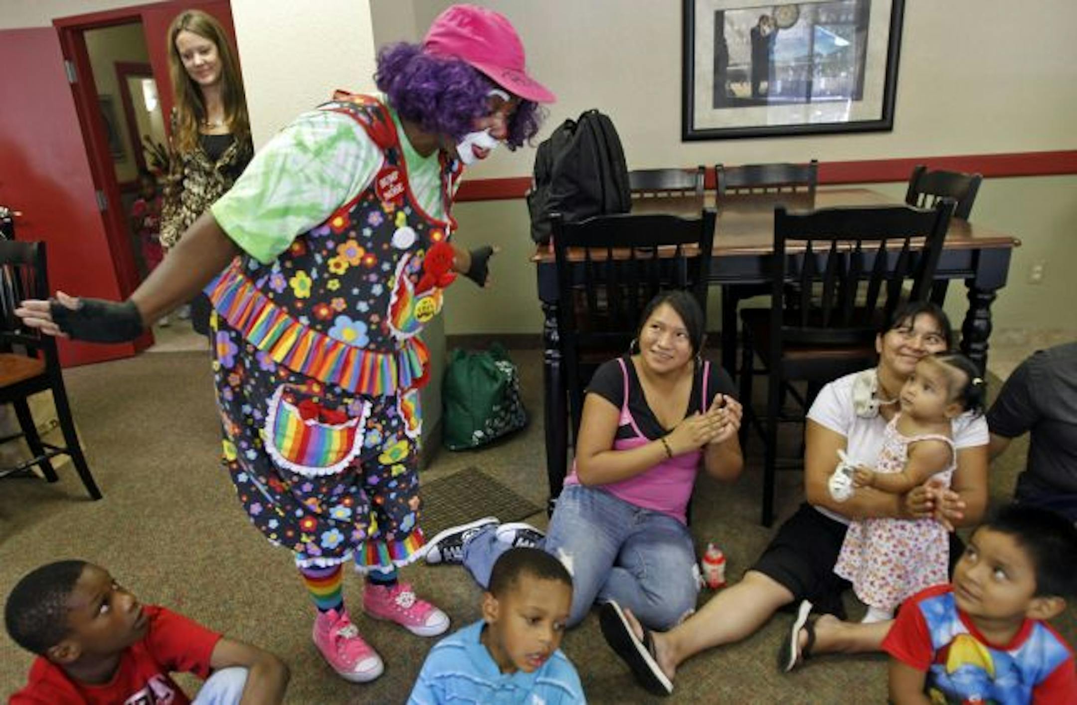 Star Grigsby, aka Pickles the Clown, entertained kids at Person to Person's Hungry Lil' Readers Club. Person to Person, a Minneapolis nonprofit, helped Grigsby with $500 for a security deposit on a new home and teamed her up with an occupational therapist who helped Grigsby take on her new career.
