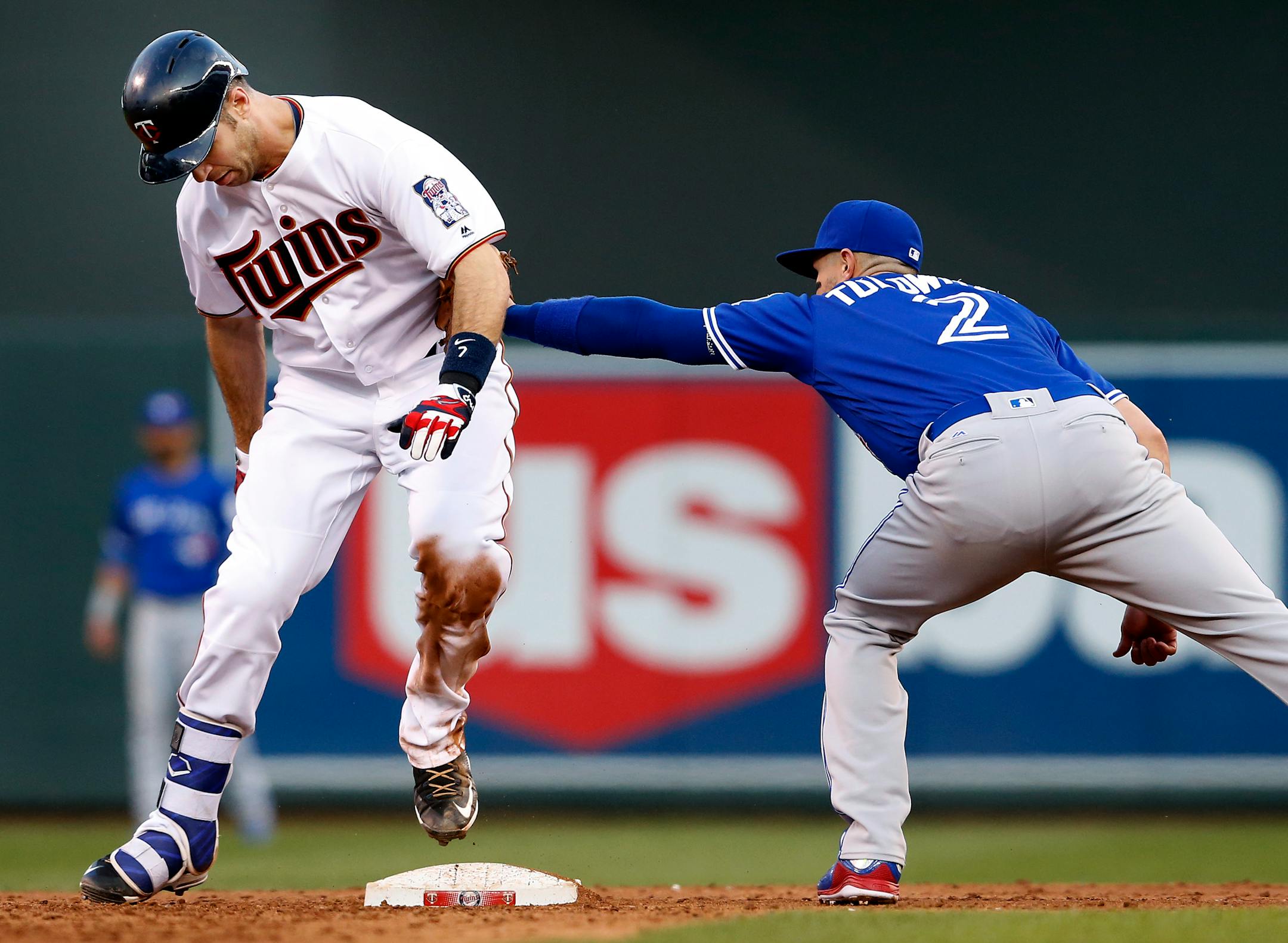Joe Mauer (7) was tagged out by Troy Tulowitzki (2) after stepping off the bag while trying to advance to second base after hitting an RBI single in the third inning.