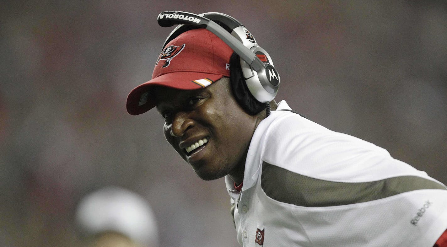 In this Sunday, Jan. 1, 2012 photo, Tampa Bay Buccaneers head coach Raheem Morris watches play against the Atlanta Falcons during the first half of an NFL football game, in Atlanta. The Buccaneers fired Raheem Morris on Monday, Jan. 2, 2012, after his three seasons as Tampa Bay's head coach. (AP Photo/David Goldman)