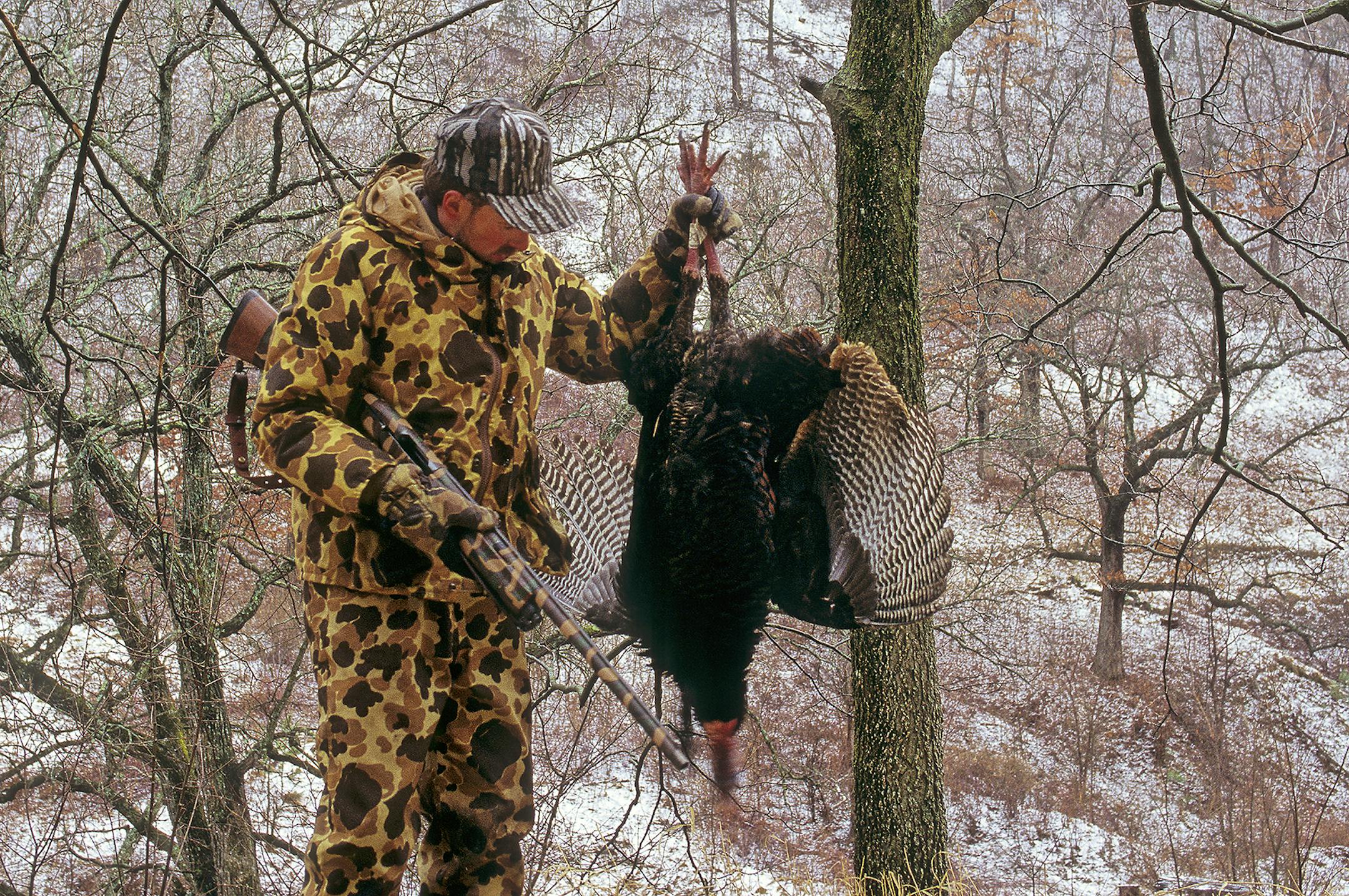 Marchel admires a big gobbler taken in blizzard-like conditions.