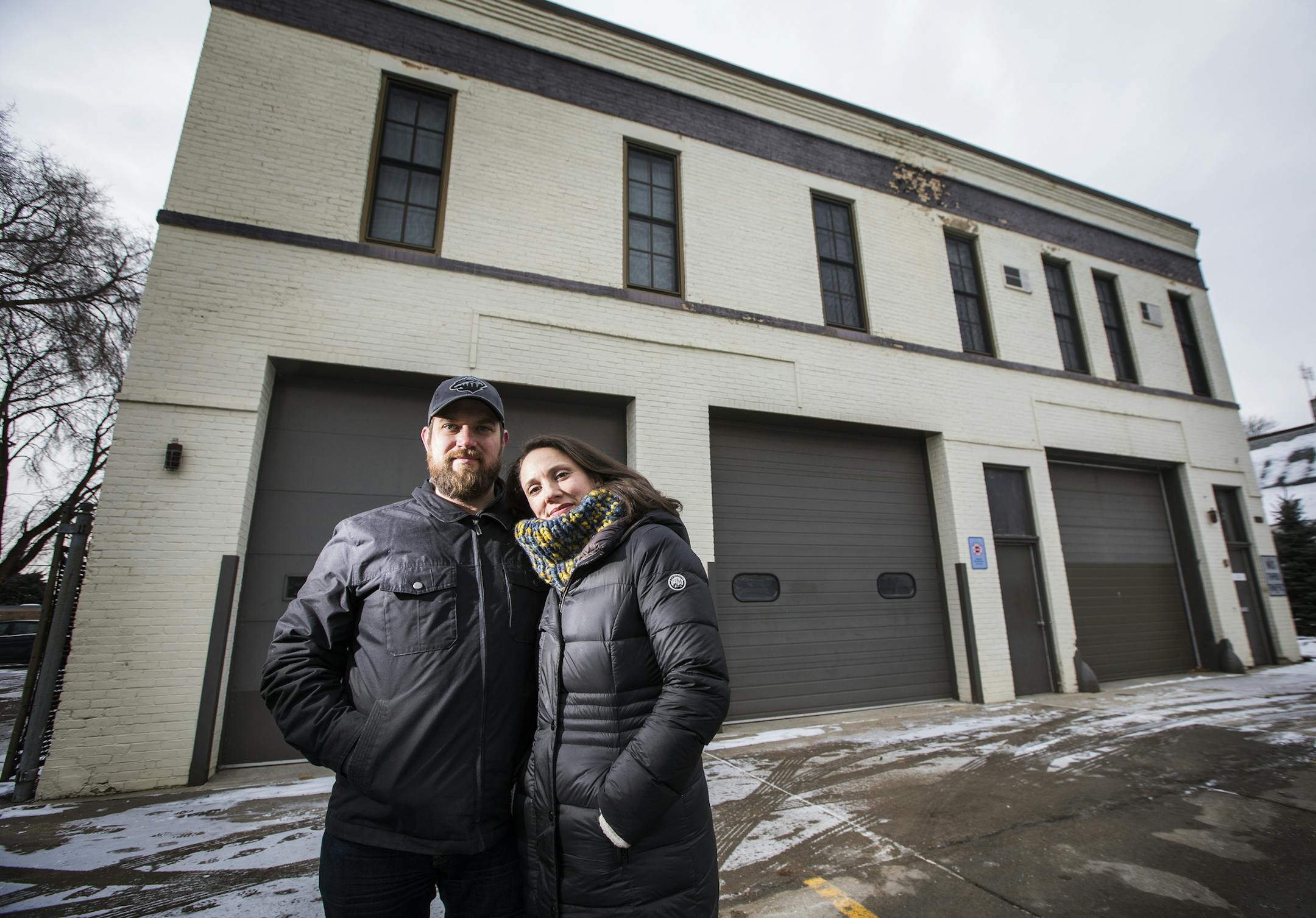 Travis Temke and his wife Justine pose at the St. Paul Fire Station on Randolph Avenue they plan to develop into a microbrewery/restaurant/coffee shop. ] LEILA NAVIDI &#xef; leila.navidi@startribune.com BACKGROUND INFORMATION: Travis Temke and his wife Justine pose at the St. Paul Fire Station they plan to develop on Thursday, December 21, 2017. They have plans to invest $1.8 million into the property to turn it into a combo microbrewery/restaurant/coffee shop, with a rooftop deck & "green patio