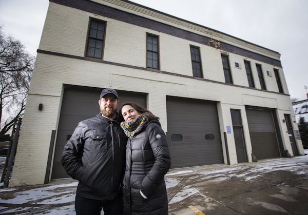 Travis Temke and his wife Justine pose at the St. Paul Fire Station on Randolph Avenue they plan to develop into a microbrewery/restaurant/coffee shop