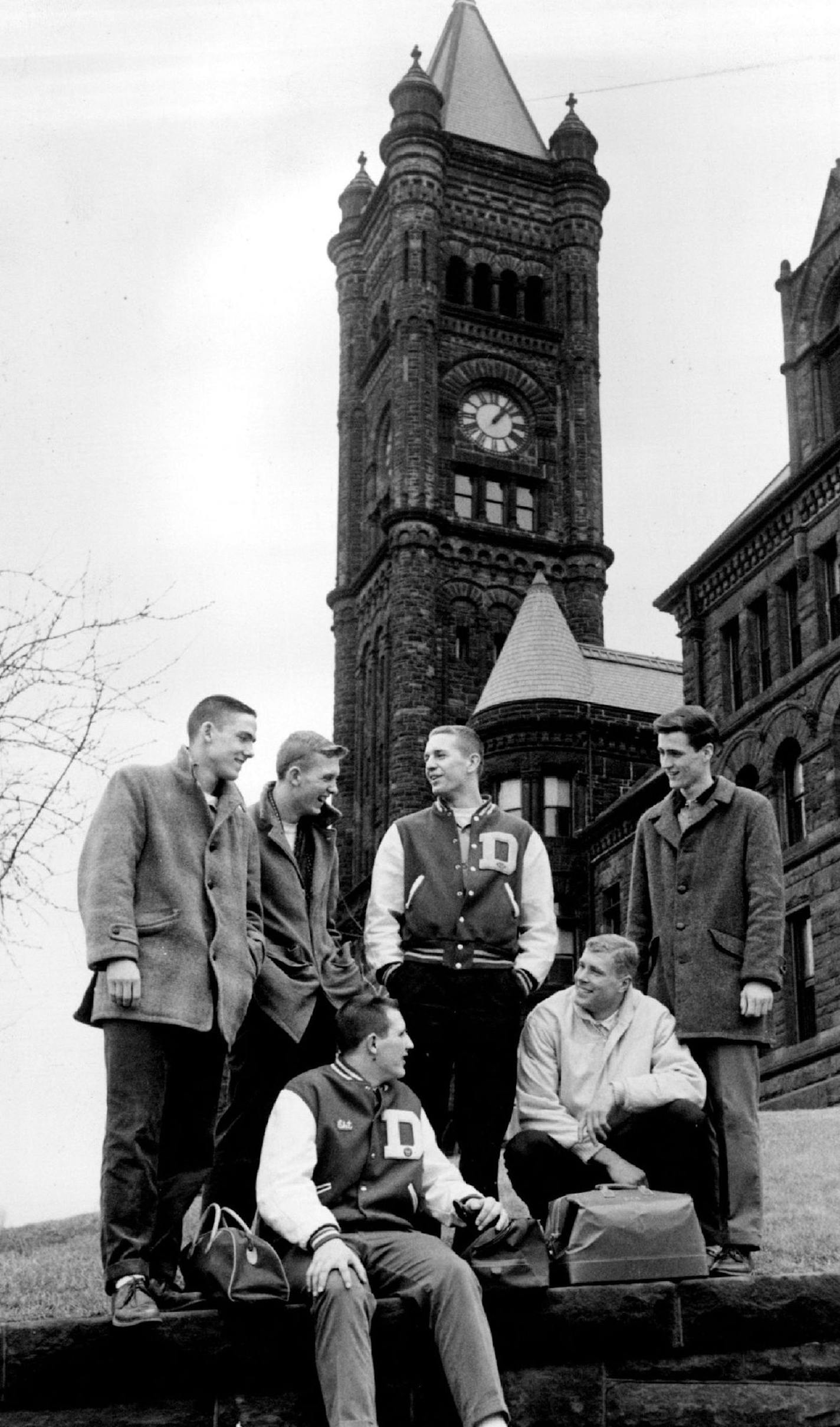 March 21, 1961 Duluth Central basketball players talk over one of the best seasons in their school's history. An the history is signified by the high school tower in background, built in 1892. Players who will compete in State tourney beginning Thursday at Williams arena are, left to right, Roger Hanson, Neil Nordvall, Chet Anderson, Wally Paschke, Dan Howard kneeling and Brian Cobb. March 22, 1961 Duluth Central Hi. Powell Krueger, Minneapolis Star Tribune