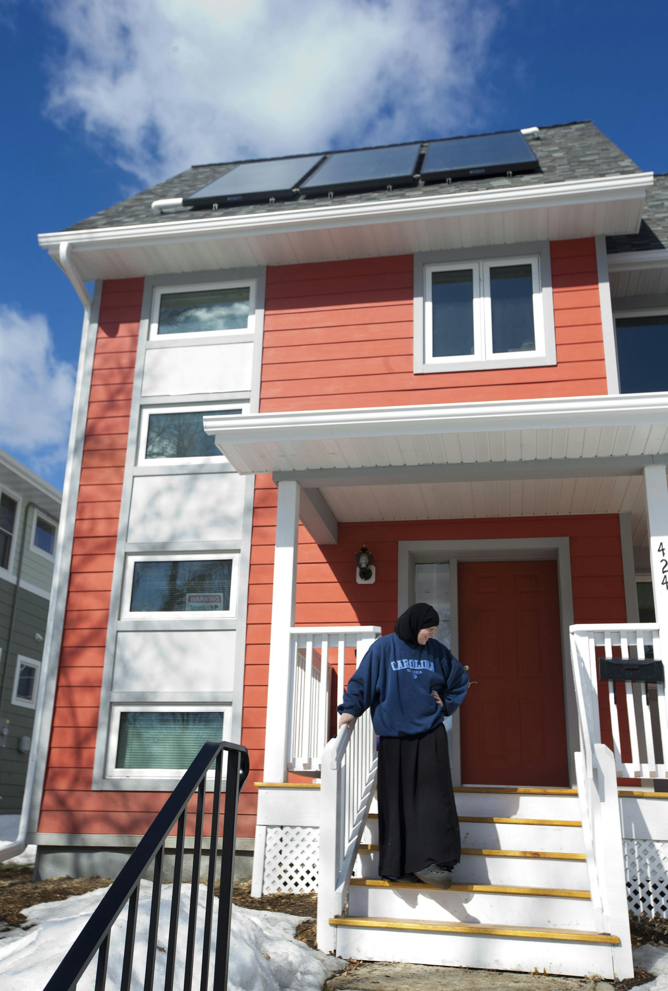 Sarah Olson posed for a picture in front of her "net zero" house in Minneapolis, Minn., on Friday, March 14, 2014. The house is an innovative project with Habitat for Humanity and students and staff of the University of Minnesota to generate as much power as it uses. ] (RENEE JONES SCHNEIDER ‚Ä¢ reneejones@startribune.com)
