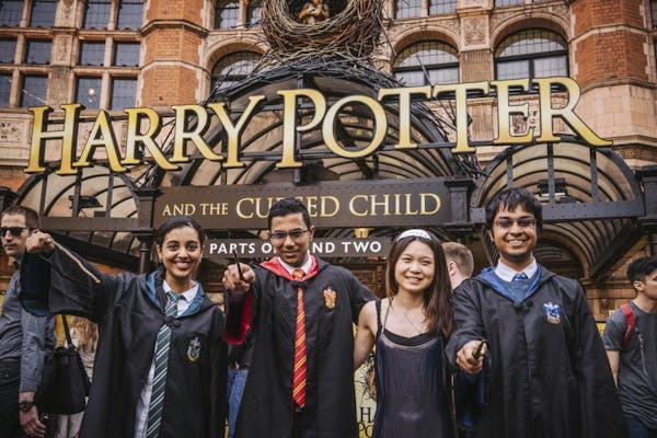 College students in Hogwarts garb who got their tickets as graduation gifts wait to see "Harry Potter and the Cursed Child" on the play's first night 