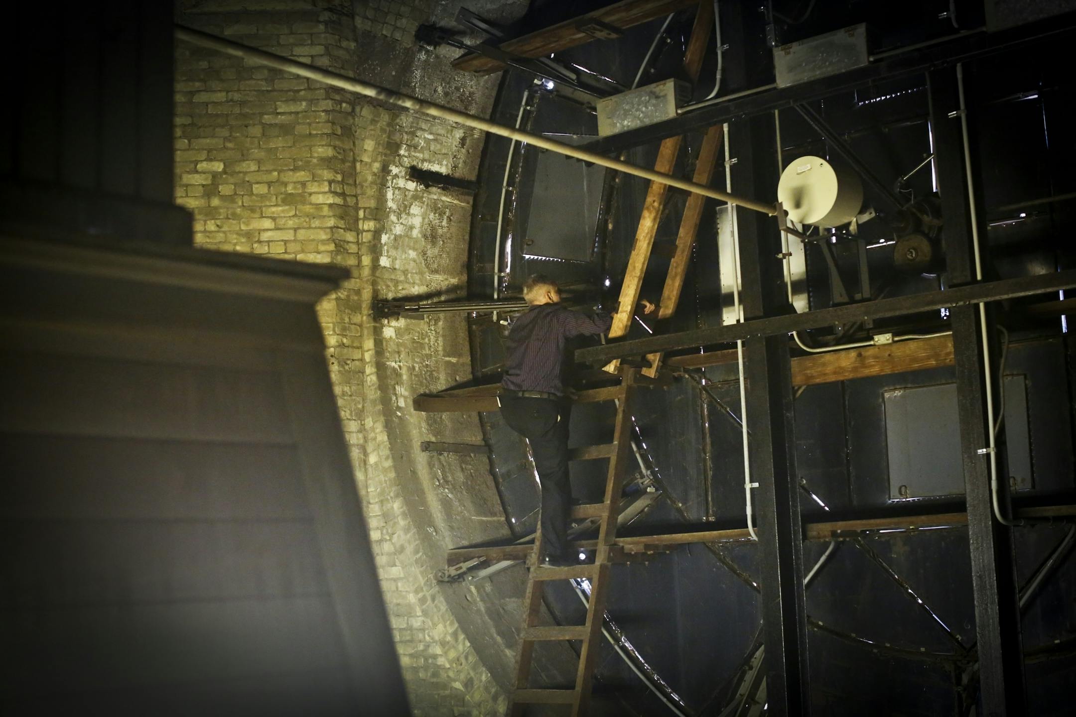 Municipal Building Commission director Jose Cervantes pointed out the damaged areas on the clock in the clock tower at city hall in Minneapolis, Minn., on Tuesday, October 16, 2012.