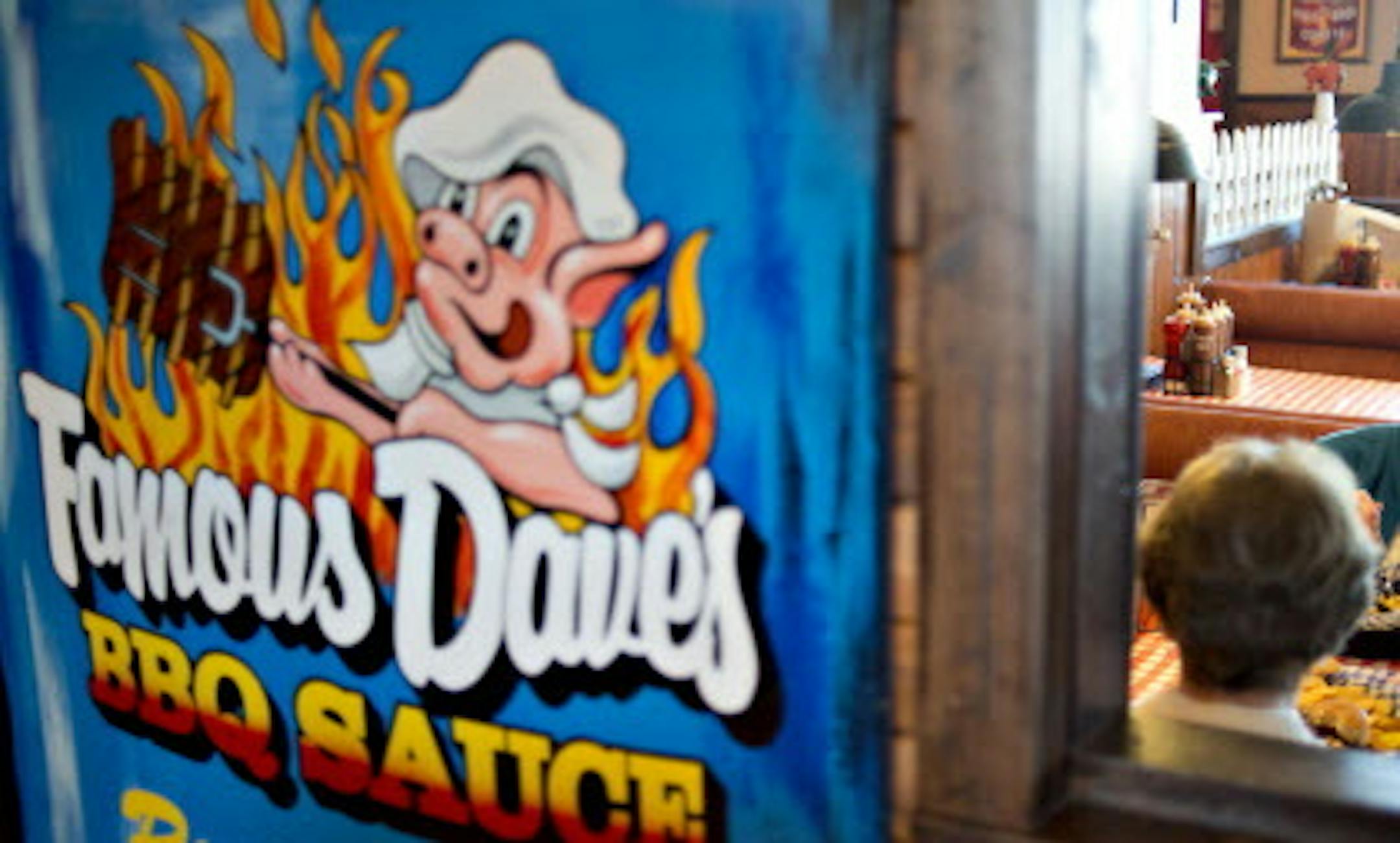 Customer Neta Moon, right, eats with a friend at a Famous Dave's of America Inc. franchise restaurant in Peoria, Illinois, U.S., on Thursday, March 21, 2013. Famous Dave's of America is a chain of barbecue restaurants started in 1994 that has 191 locations in 34 U.S. states and one Canadian province. Photographer: Daniel Acker/Bloomberg *** Local Caption *** Neta Moon