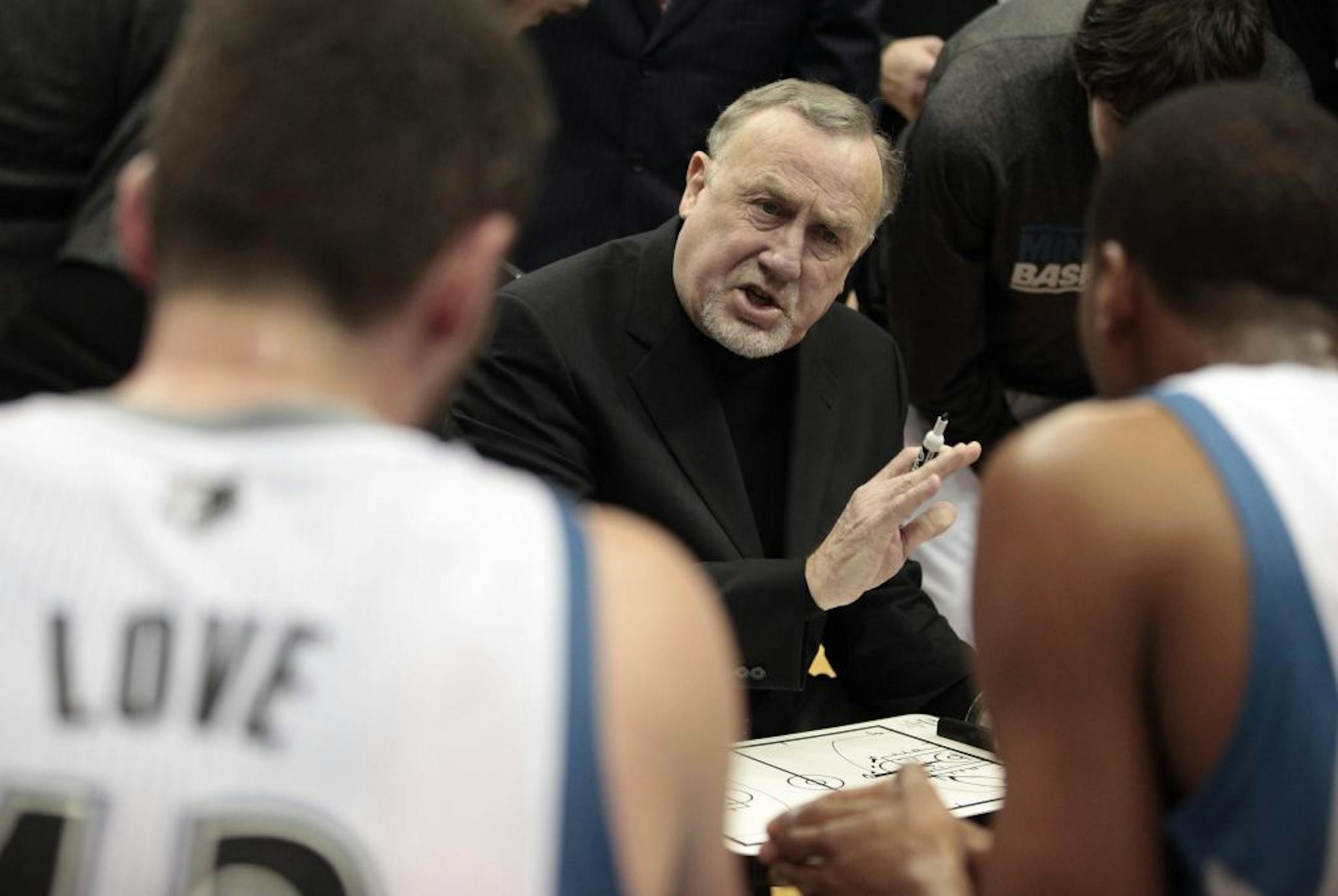 Minnesota Timberwolves head coach Rick Adelman, center, talks with his team during a timeout against the Milwaukee Bucks in the second half of an NBA preseason basketball game, Saturday, Dec. 17, 2011, in Minneapolis. The Timberwolves won 117-96.